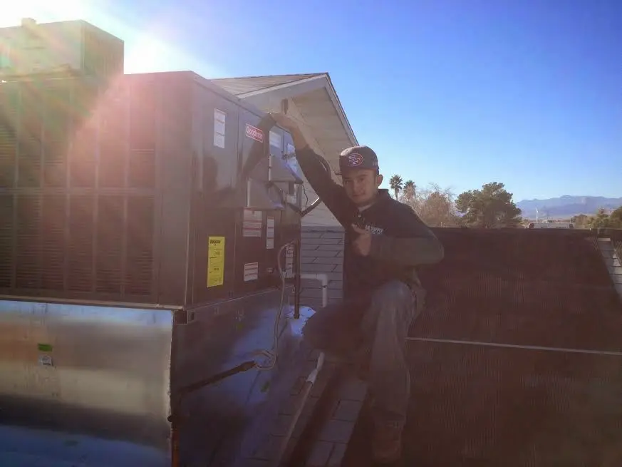 HVAC technician performing Boiler Repair on a rooftop unit in Union